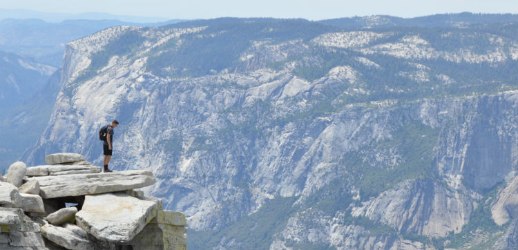 man_looking_over_cliff